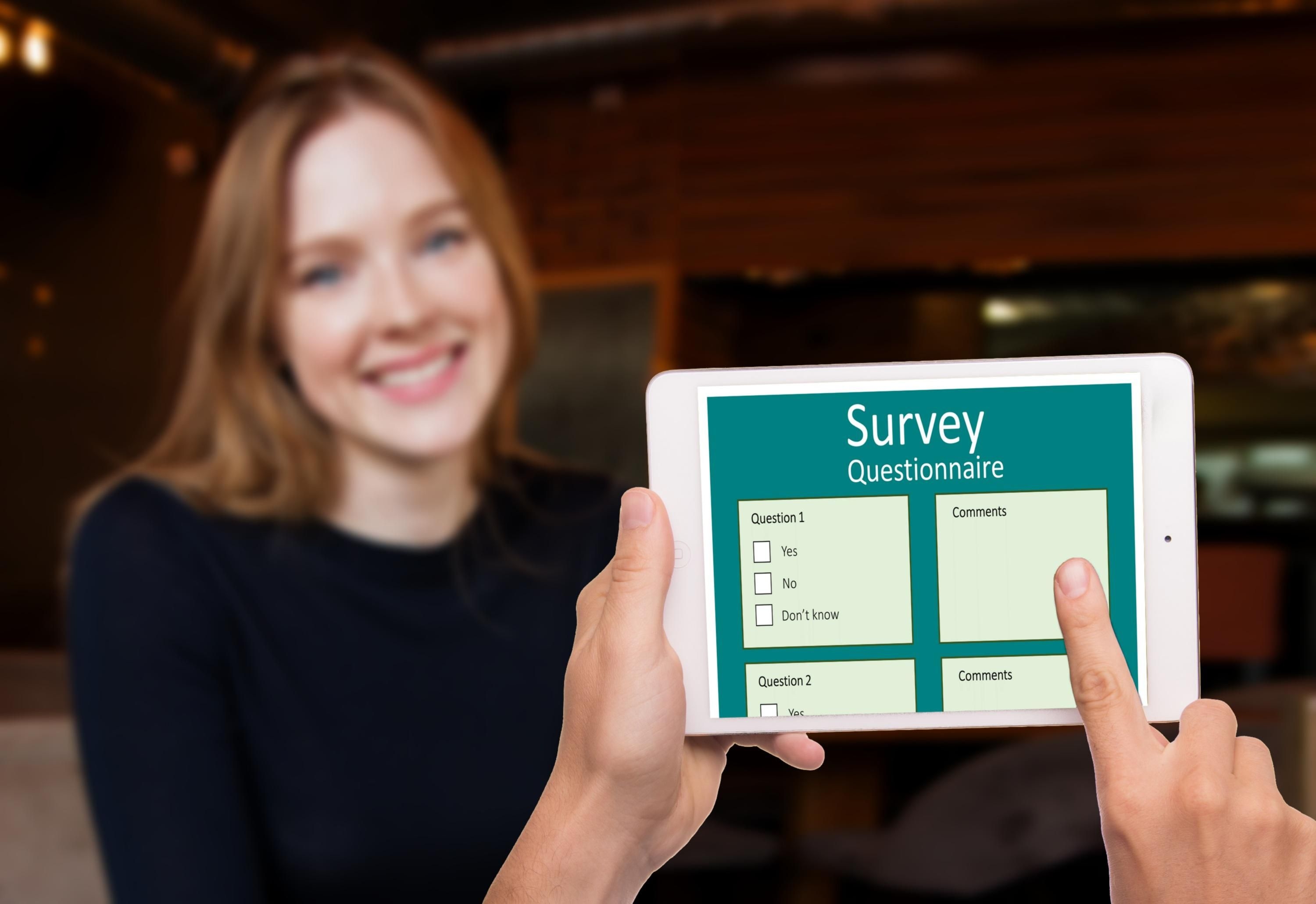 A woman fills in a digital survey on a tablet, one of the methods used to assess local digital needs. A woman fills in a digital survey on a tablet, one of the methods used to assess local digital needs.